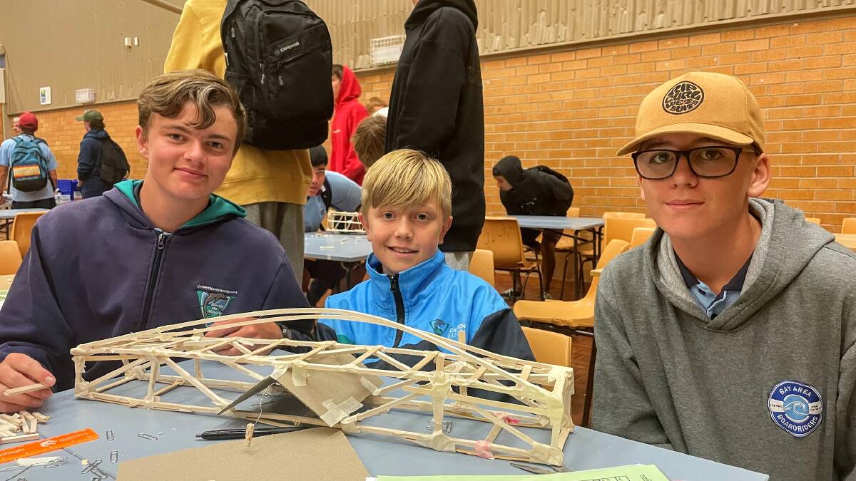 Camden Haven High School students Elwood Dollery, Lawson Cooper and Ryder Binks have been buiding a bridge to carry at least 1 kilogram as part of the Science and Engineering Challenge. Picture by Emily Walker